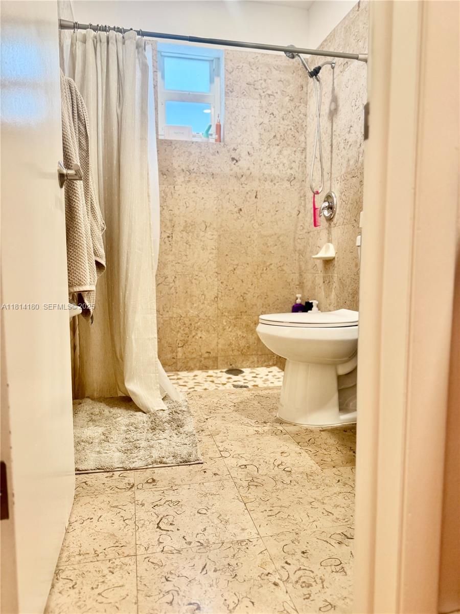 220 Northwest 130th Avenue Miami, FL 33182 - Photo 18 of 32 a bathroom with a toilet sink and shower