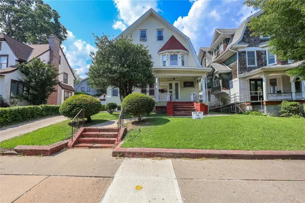 a front view of a house with a yard