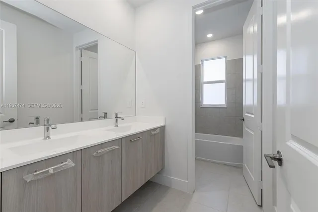 a bathroom with a double vanity sink and mirror