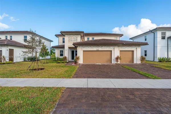 a front view of a house with a yard and garage