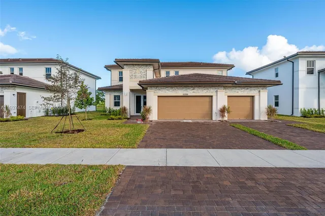 a front view of a house with a yard and garage