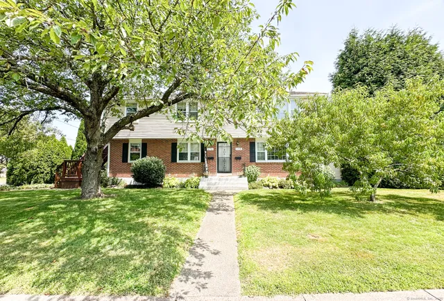 a front view of a house with a yard