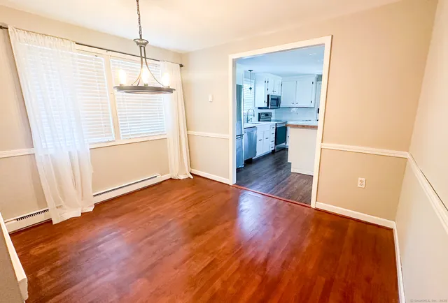 a view of a kitchen with wooden floor and a kitchen
