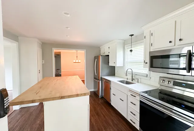 a kitchen with a sink stove and refrigerator