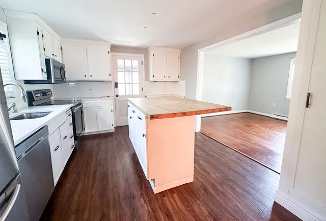 a kitchen with a stove a sink and a refrigerator