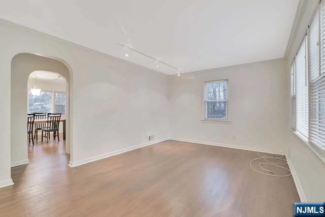 69 County Road Cresskill, NJ 07626 - Photo 3 of 20 an empty room with wooden floor and a window
