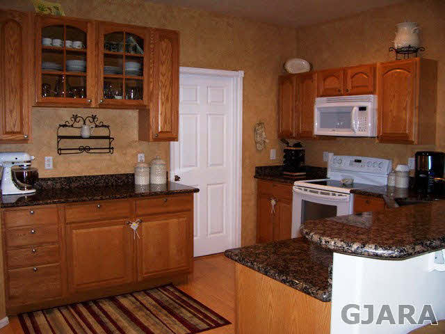 4419 1900th Road Delta, CO 81416 - Photo 5 of 13 a kitchen with stainless steel appliances granite countertop a stove a sink and a microwave