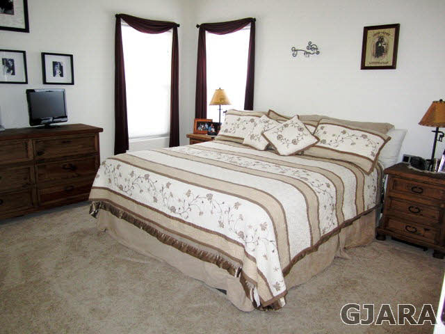 4419 1900th Road Delta, CO 81416 - Photo 8 of 13 a bedroom with a bed and a flat tv screen on dresser