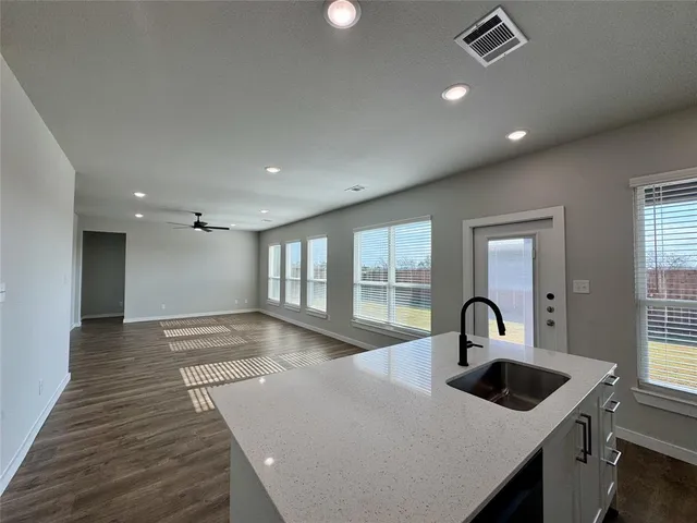 a kitchen with a sink and living room