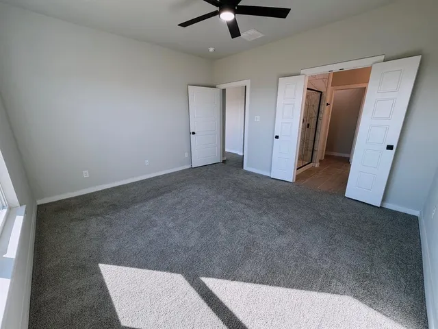 a spacious bathroom with double sink and mirror