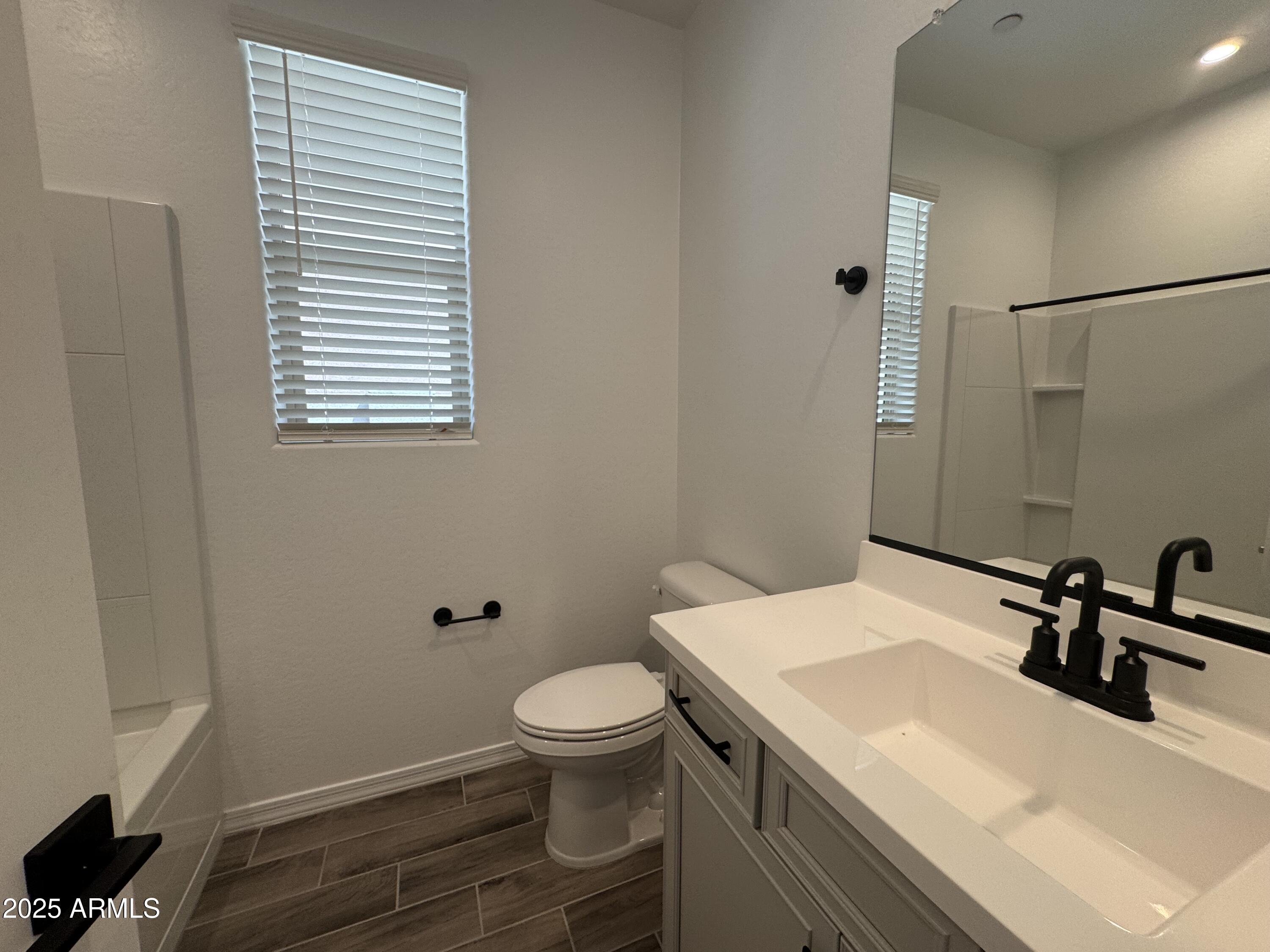 13420 West Eagle Feather Road Peoria, AZ 85383 - Photo 11 of 23 a bathroom with a sink toilet and mirror
