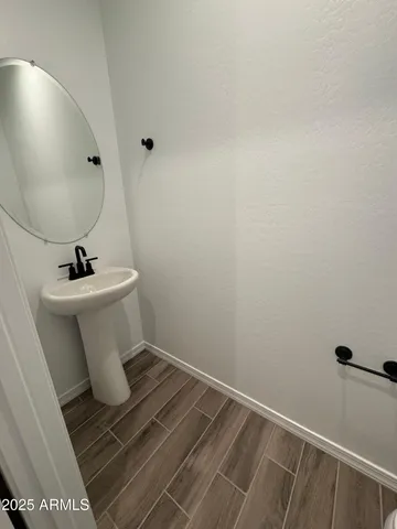 a bathroom with a sink toilet and mirror