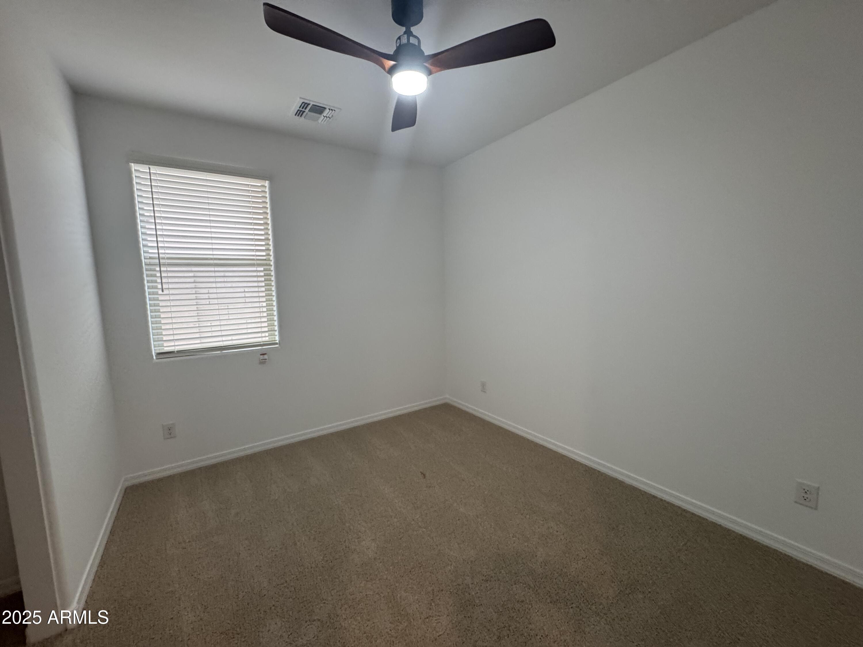 13420 West Eagle Feather Road Peoria, AZ 85383 - Photo 14 of 23 an empty room with a window and a fan
