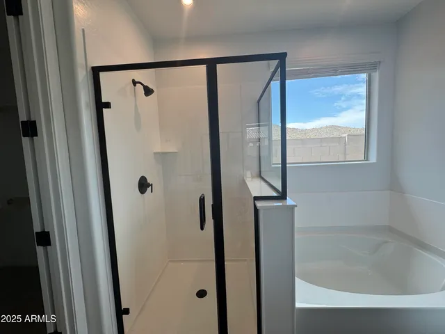 a bathroom with a glass shower door