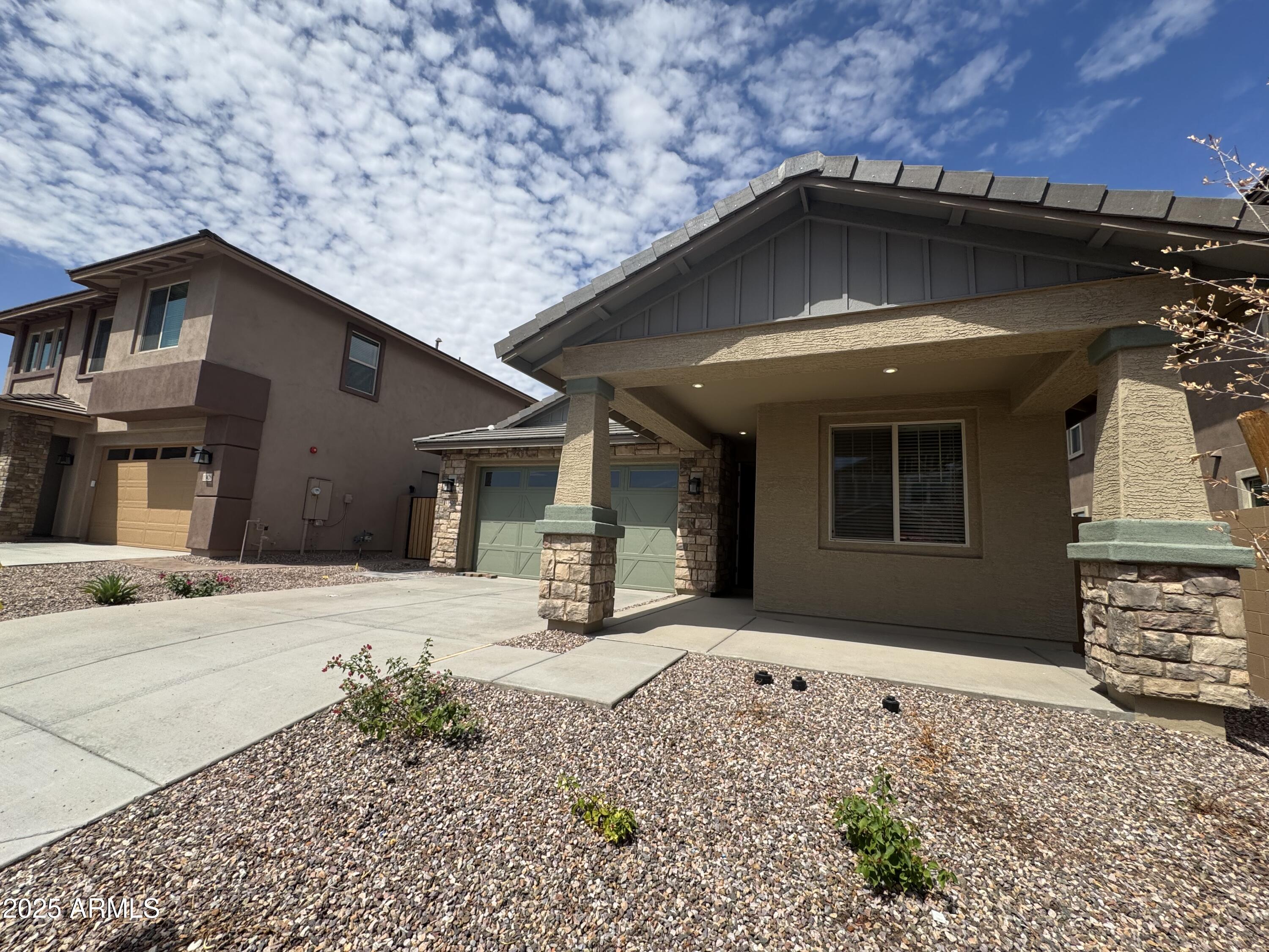 13420 West Eagle Feather Road Peoria, AZ 85383 - Photo 2 of 23 a yellow house with a outdoor space