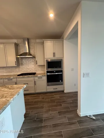a kitchen with kitchen island granite countertop a stove and a refrigerator
