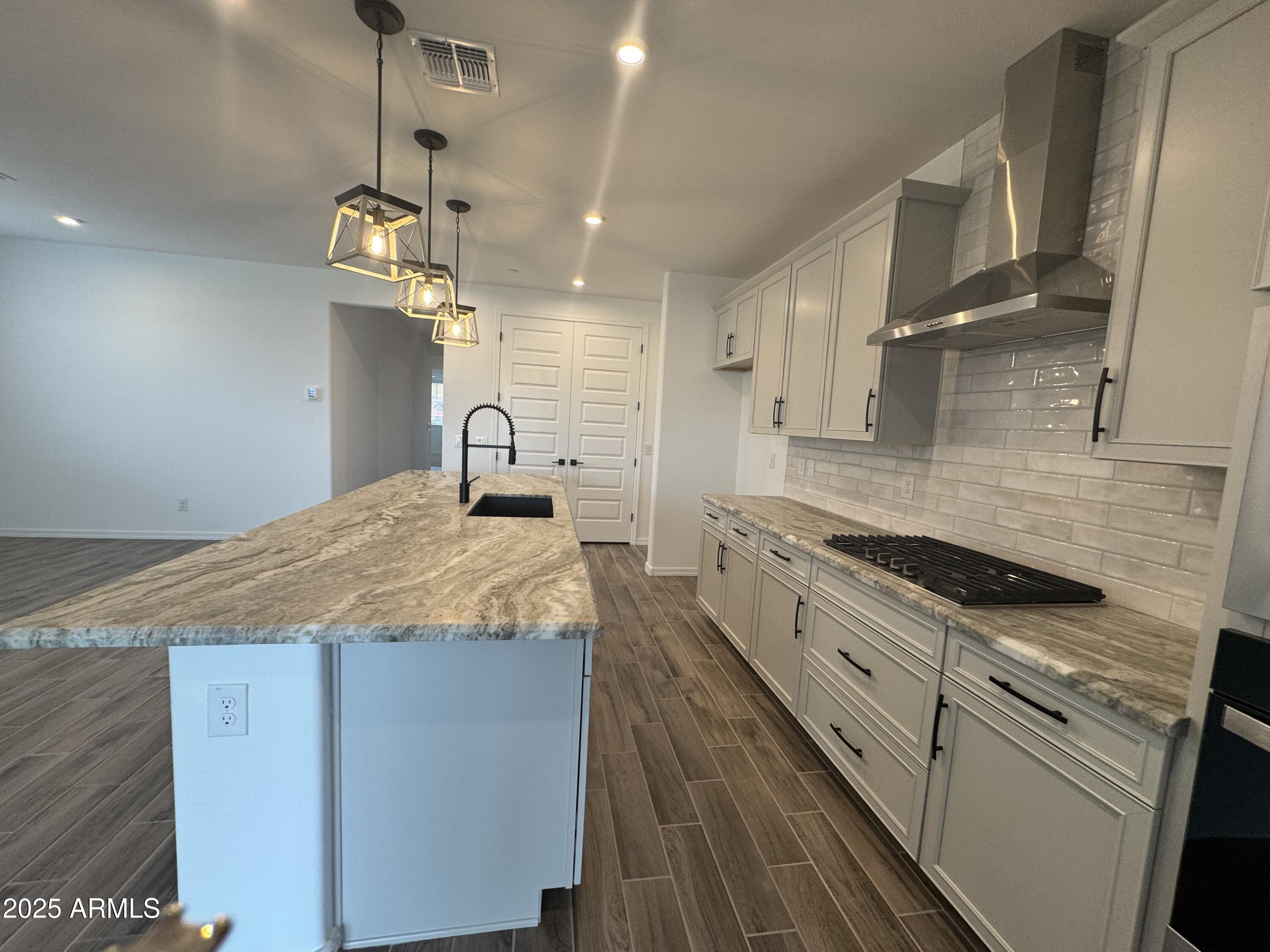 13420 West Eagle Feather Road Peoria, AZ 85383 - Photo 8 of 23 a kitchen with granite countertop cabinets a sink and stainless steel appliances