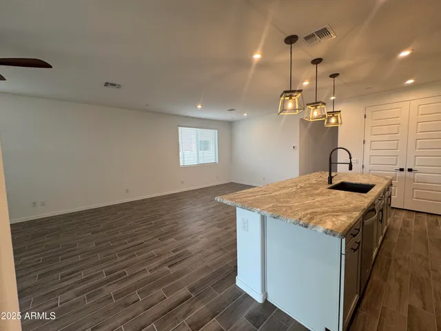 a kitchen with a sink and chandelier