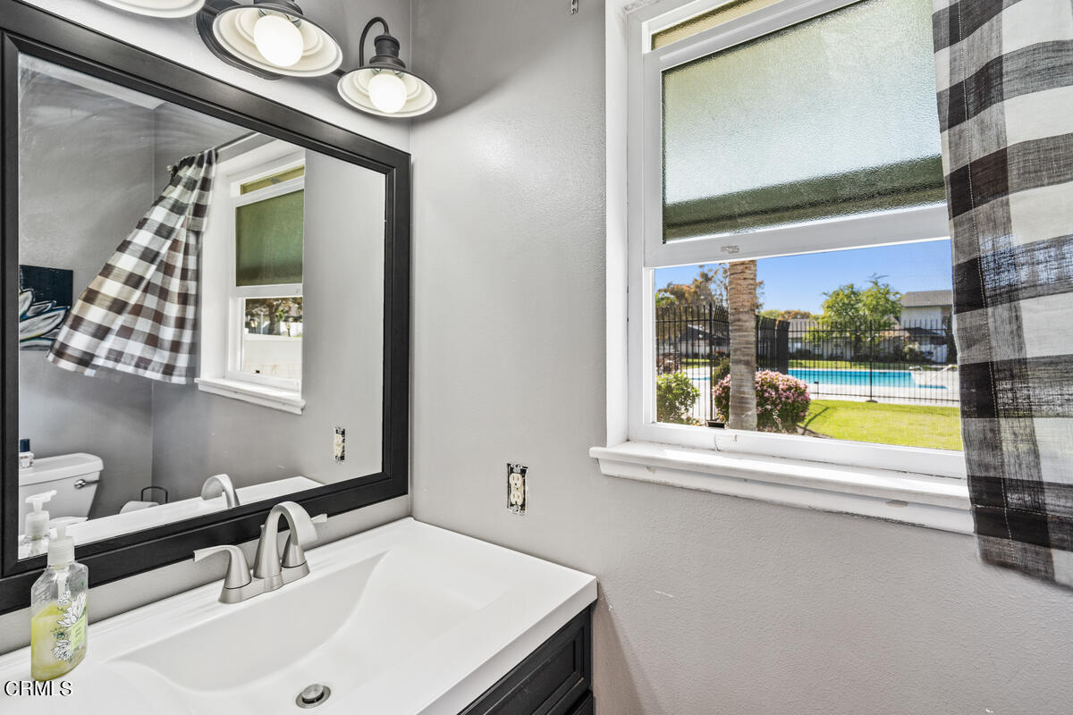 2117 Miramar Walk Oxnard, CA 93035 - Photo 11 of 30 a bathroom with a sink and a large mirror