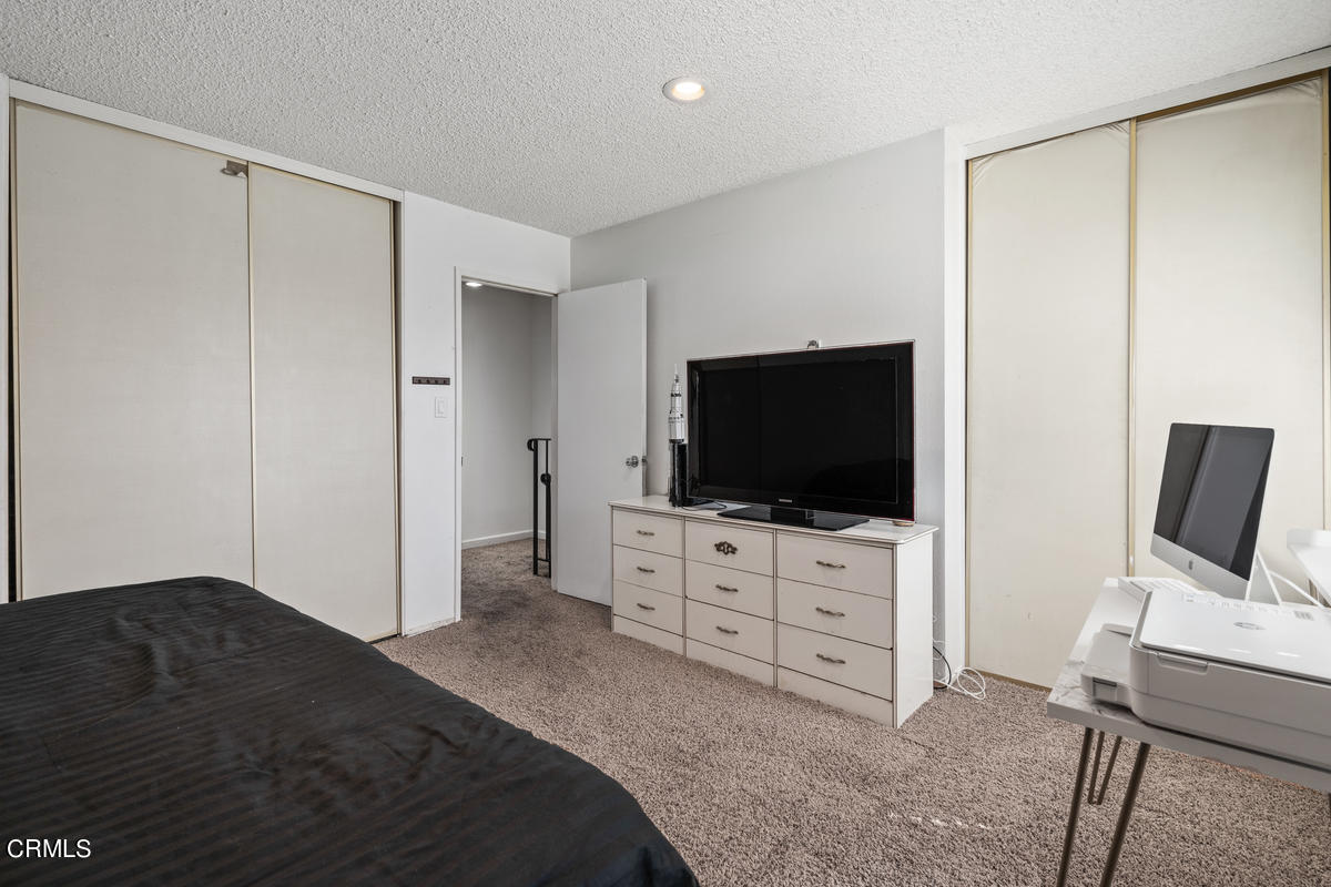 2117 Miramar Walk Oxnard, CA 93035 - Photo 13 of 30 a bedroom with a bed and flat screen tv
