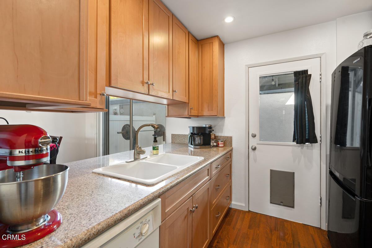 2117 Miramar Walk Oxnard, CA 93035 - Photo 10 of 30 a kitchen with stainless steel appliances granite countertop a sink a stove and a refrigerator