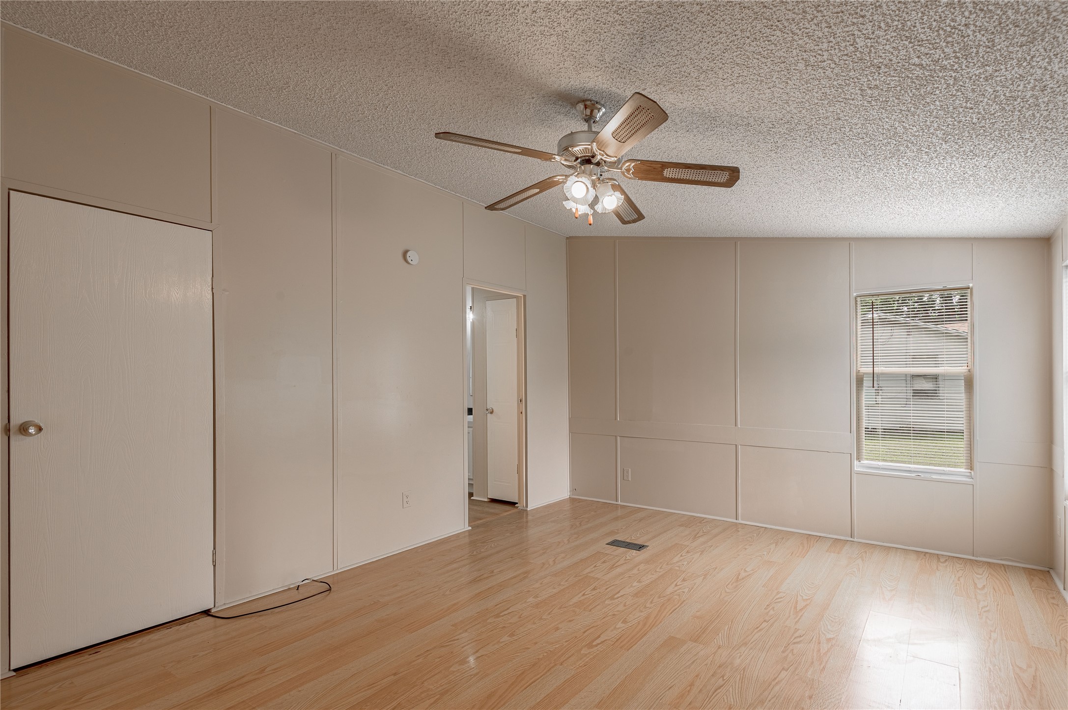 1323 Avenue East Huntsville, TX 77340 - Photo 11 of 28 an empty room with wooden floor closet and windows