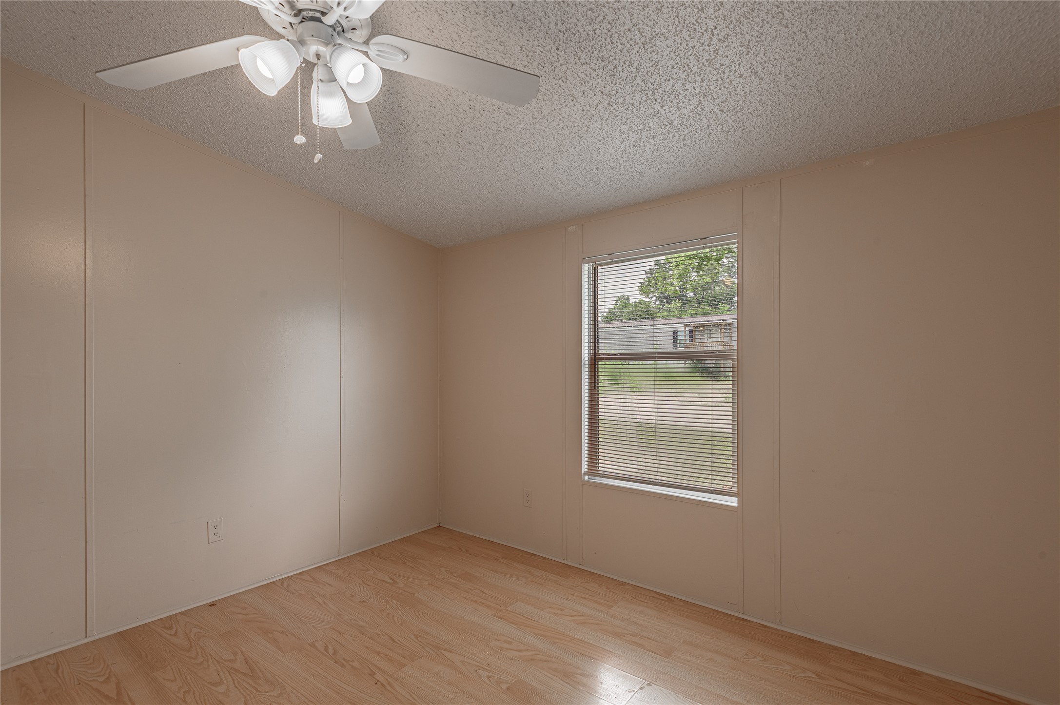 1323 Avenue East Huntsville, TX 77340 - Photo 18 of 28 an empty room with windows and chandelier fan