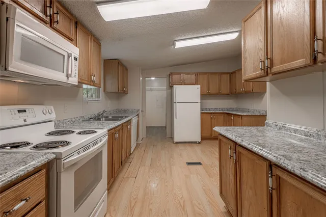 a kitchen with a stove top oven and cabinets
