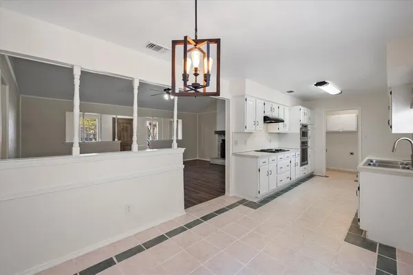 a kitchen with stainless steel appliances a refrigerator and cabinets