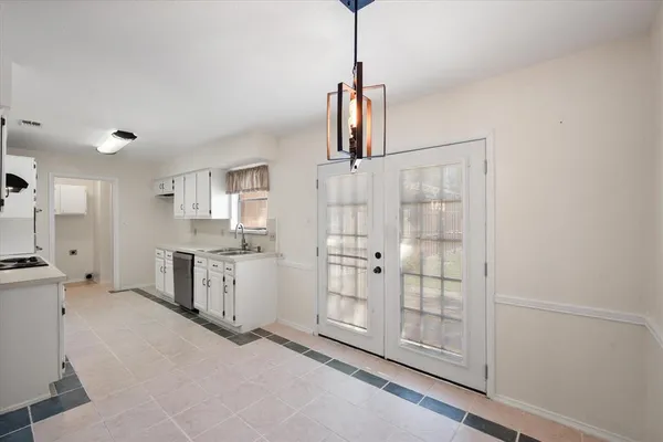 a open kitchen with white cabinets and stainless steel appliances