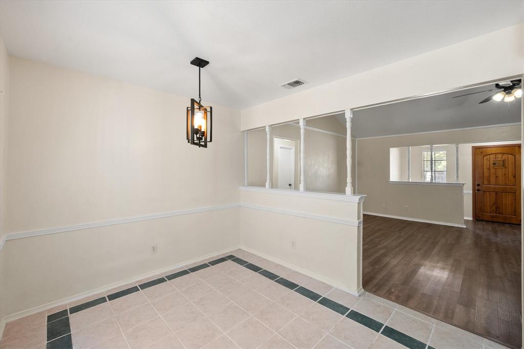 505 Meadow Ridge Drive Cedar Hill, TX 75104 - Photo 15 of 32 an empty room with wooden floor and windows