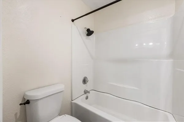 a bathroom with a bathtub and a toilet