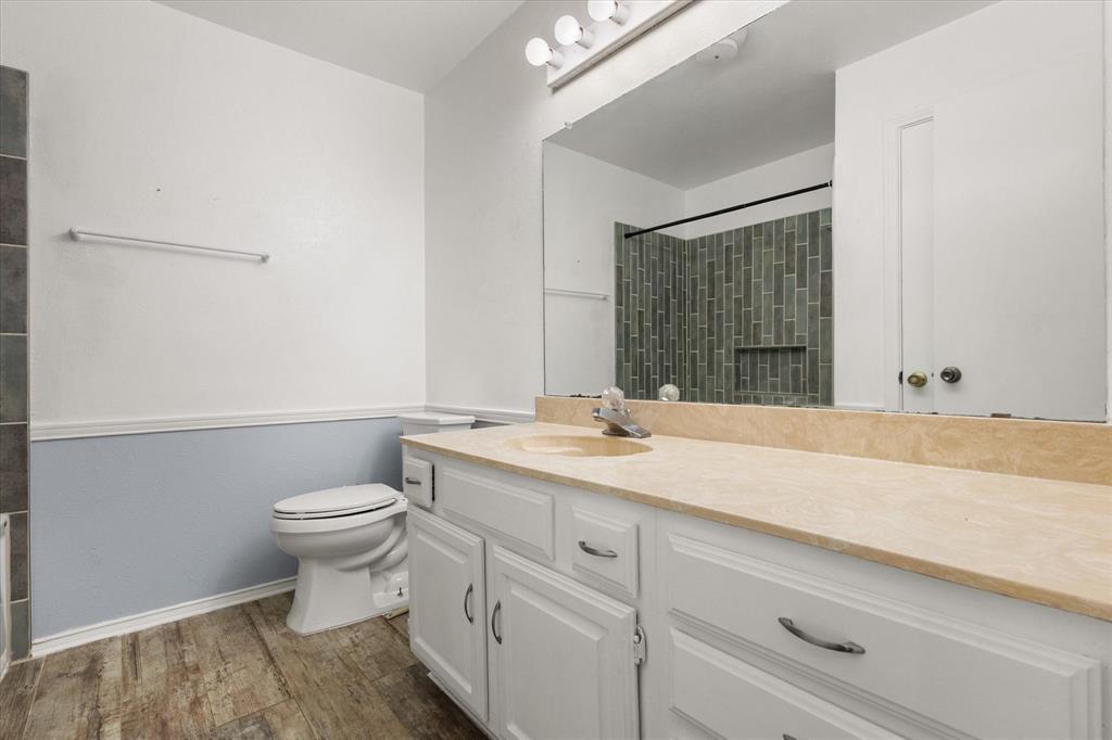 505 Meadow Ridge Drive Cedar Hill, TX 75104 - Photo 21 of 32 a bathroom with a granite countertop sink mirror vanity and toilet