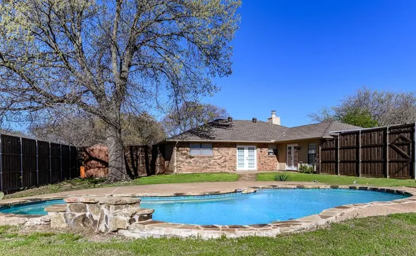 a view of a house with swimming pool and porch with furniture