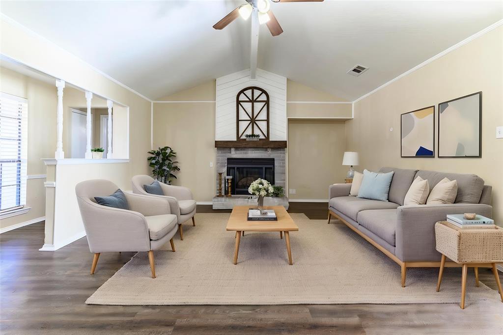 505 Meadow Ridge Drive Cedar Hill, TX 75104 - Photo 5 of 32 a living room with furniture a fireplace and a chandelier