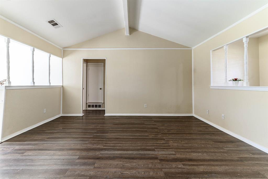 505 Meadow Ridge Drive Cedar Hill, TX 75104 - Photo 7 of 32 a view of an empty room with wooden floor and a window