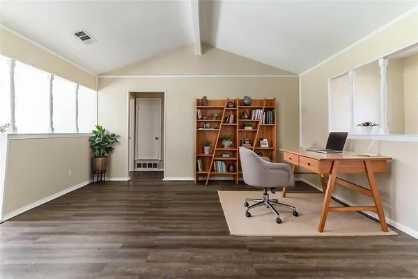 a workspace with furniture wooden floor and windows