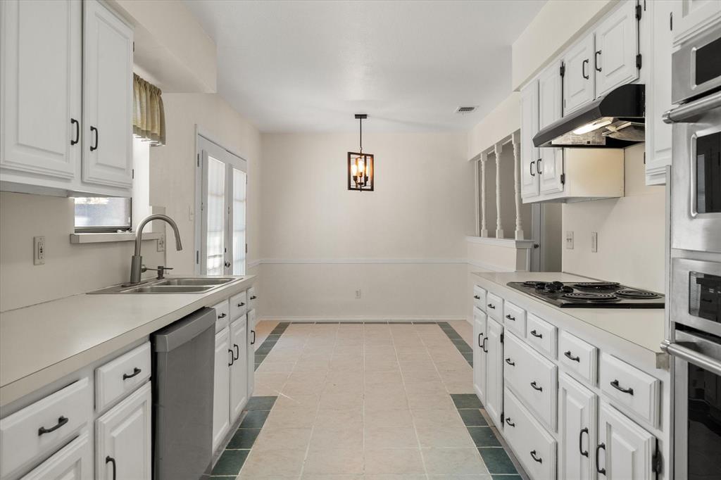 505 Meadow Ridge Drive Cedar Hill, TX 75104 - Photo 9 of 32 a kitchen with stainless steel appliances a sink stove and cabinets