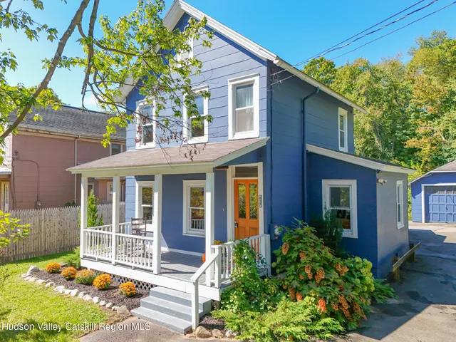 a front view of a house with a garden