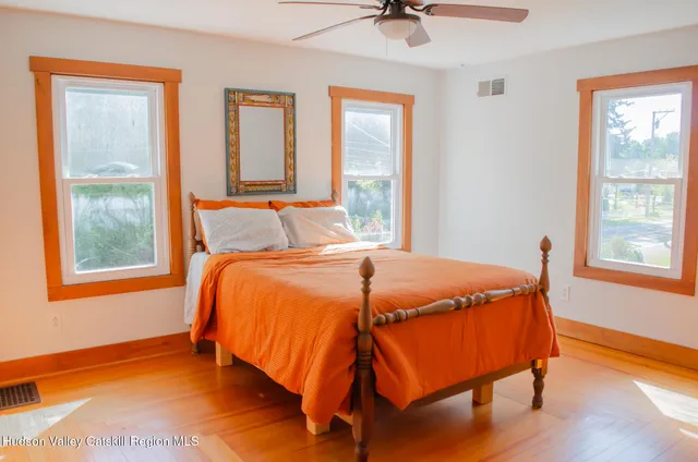 a bed sitting in a bedroom next to a window