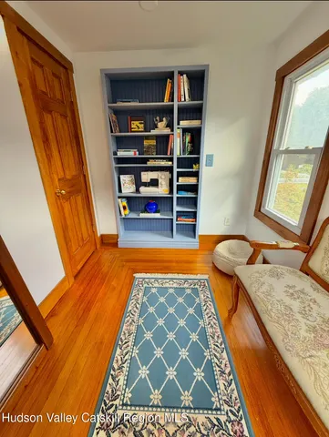 a bedroom with furniture and a rug