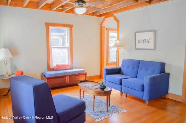 a living room with furniture a chair and a window
