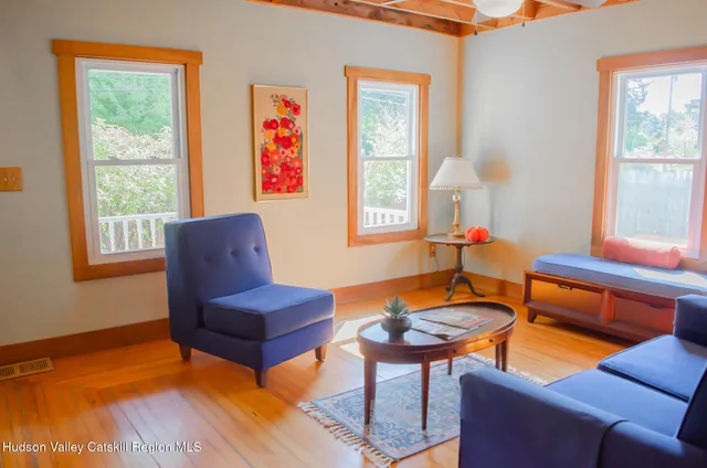 a living room with furniture a flat screen tv and a window