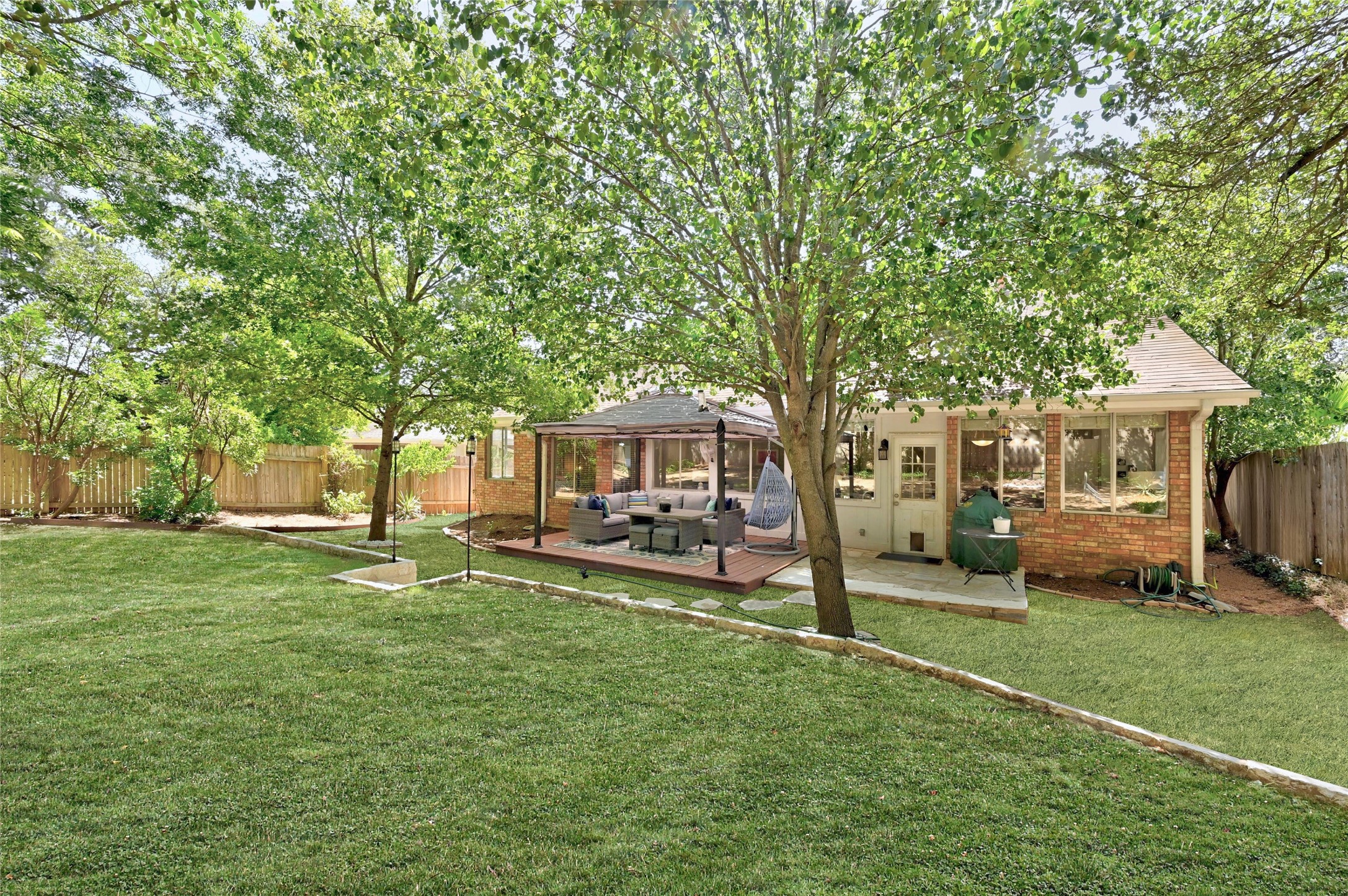 10906 Redgate Lane Austin, TX 78739 - Photo 25 of 25 Backyard - virtual enhancement of lower level grass