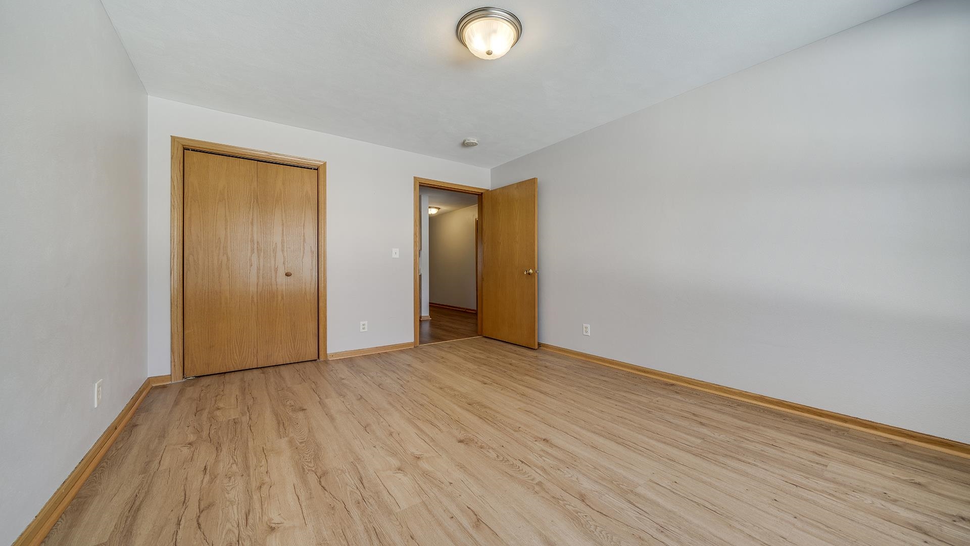 443 Mill Ridge Drive Byron, IL 61010 - Photo 21 of 25 a view of an empty room with wooden floor and closet
