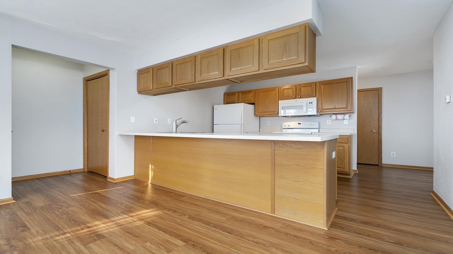 443 Mill Ridge Drive Byron, IL 61010 - Photo 4 of 25 a view of a kitchen with wooden floor and cabinets