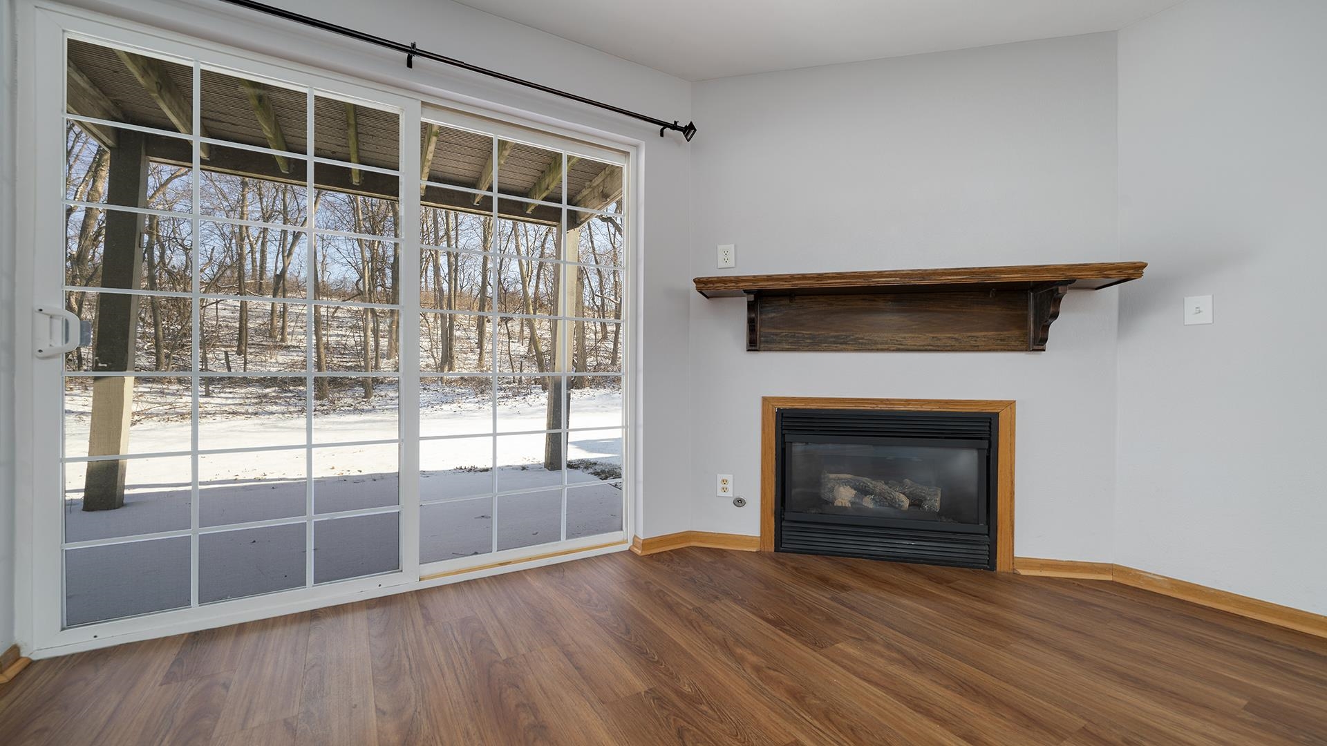 443 Mill Ridge Drive Byron, IL 61010 - Photo 6 of 25 a view of an empty room with wooden floor and a fireplace
