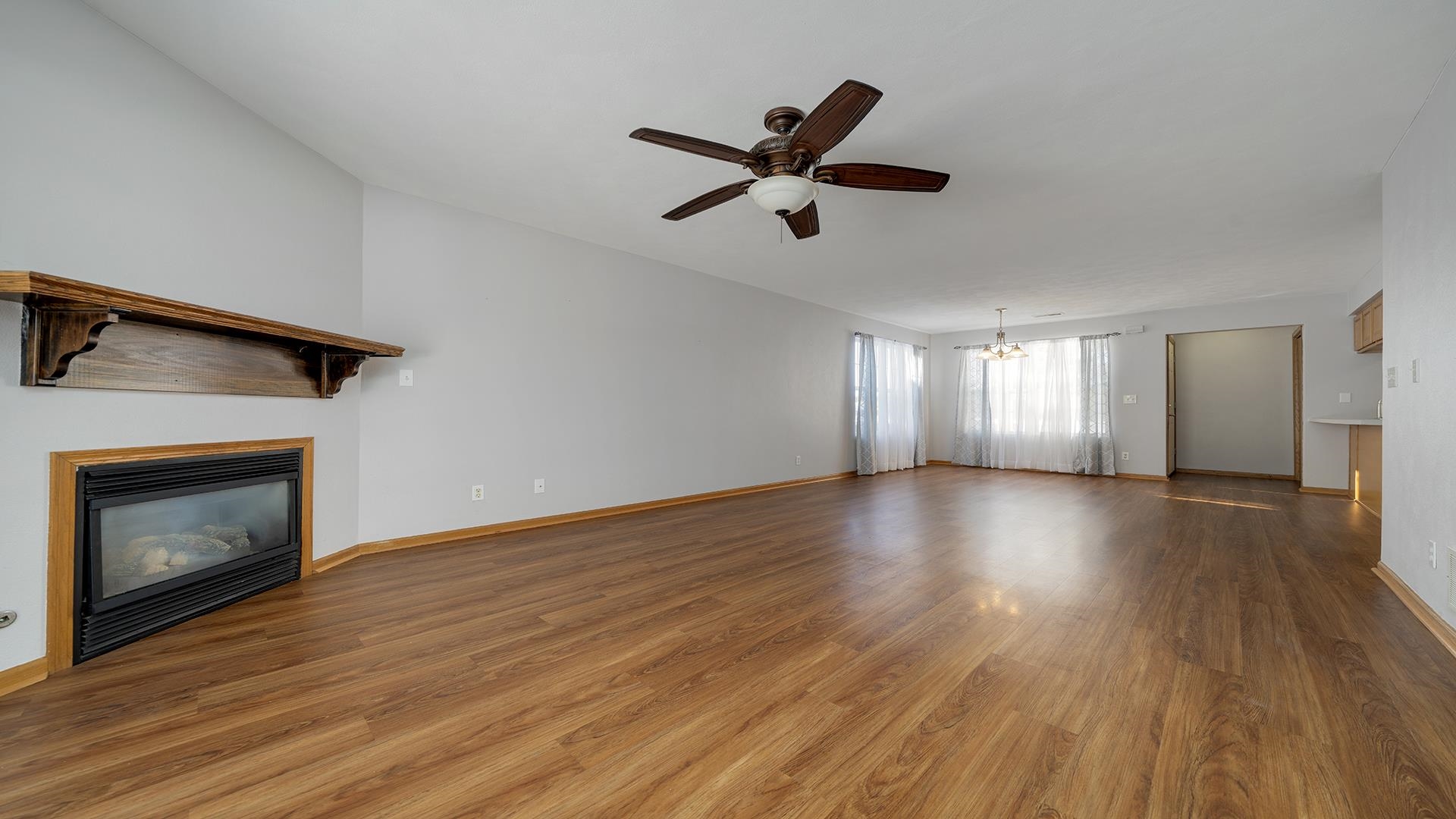 443 Mill Ridge Drive Byron, IL 61010 - Photo 7 of 25 a view of an empty room with wooden floor and a fireplace