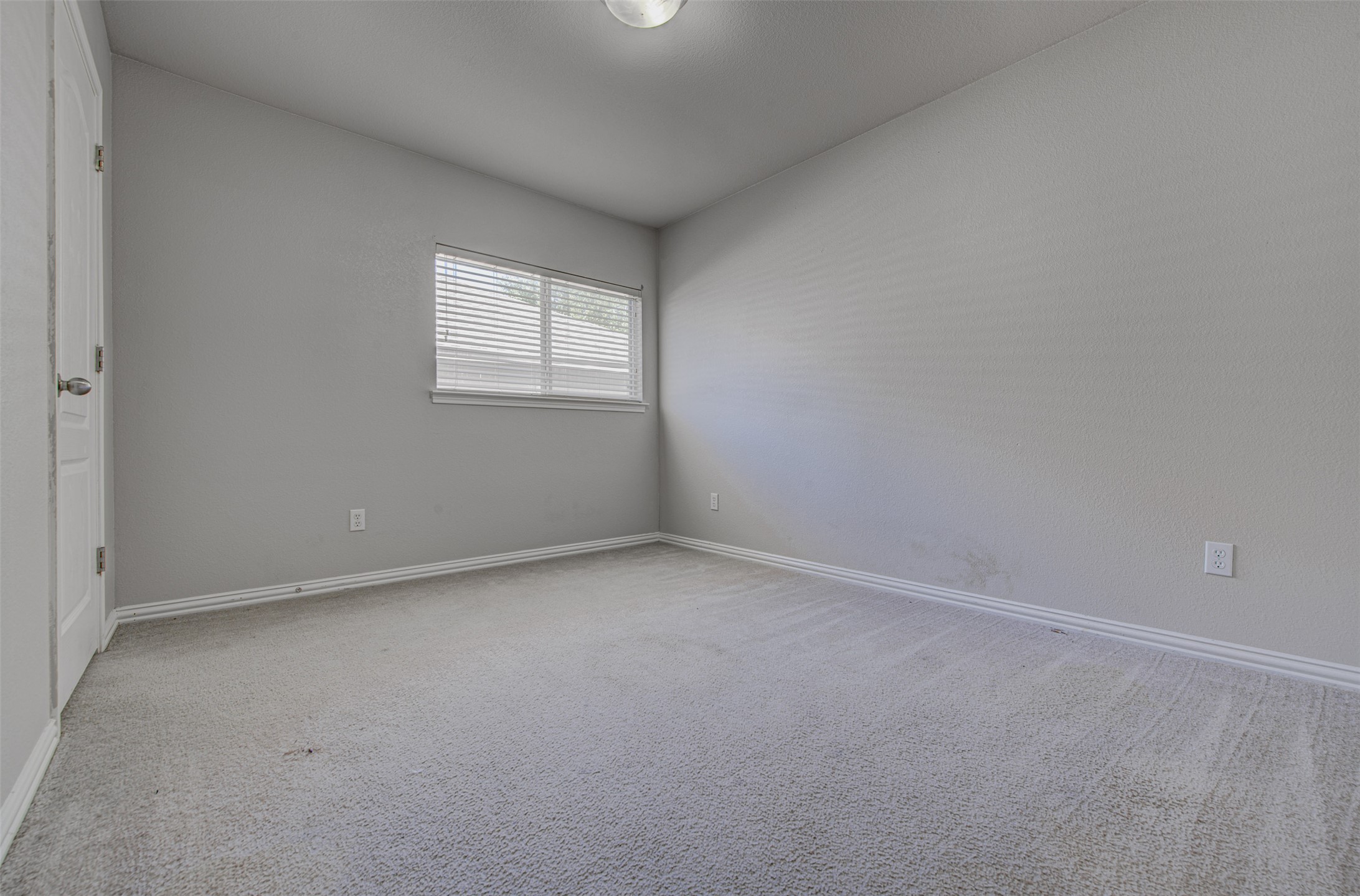 2090 Intrepid Drive Buda, TX 78610 - Photo 18 of 24 Spare room featuring light colored carpet and baseboards