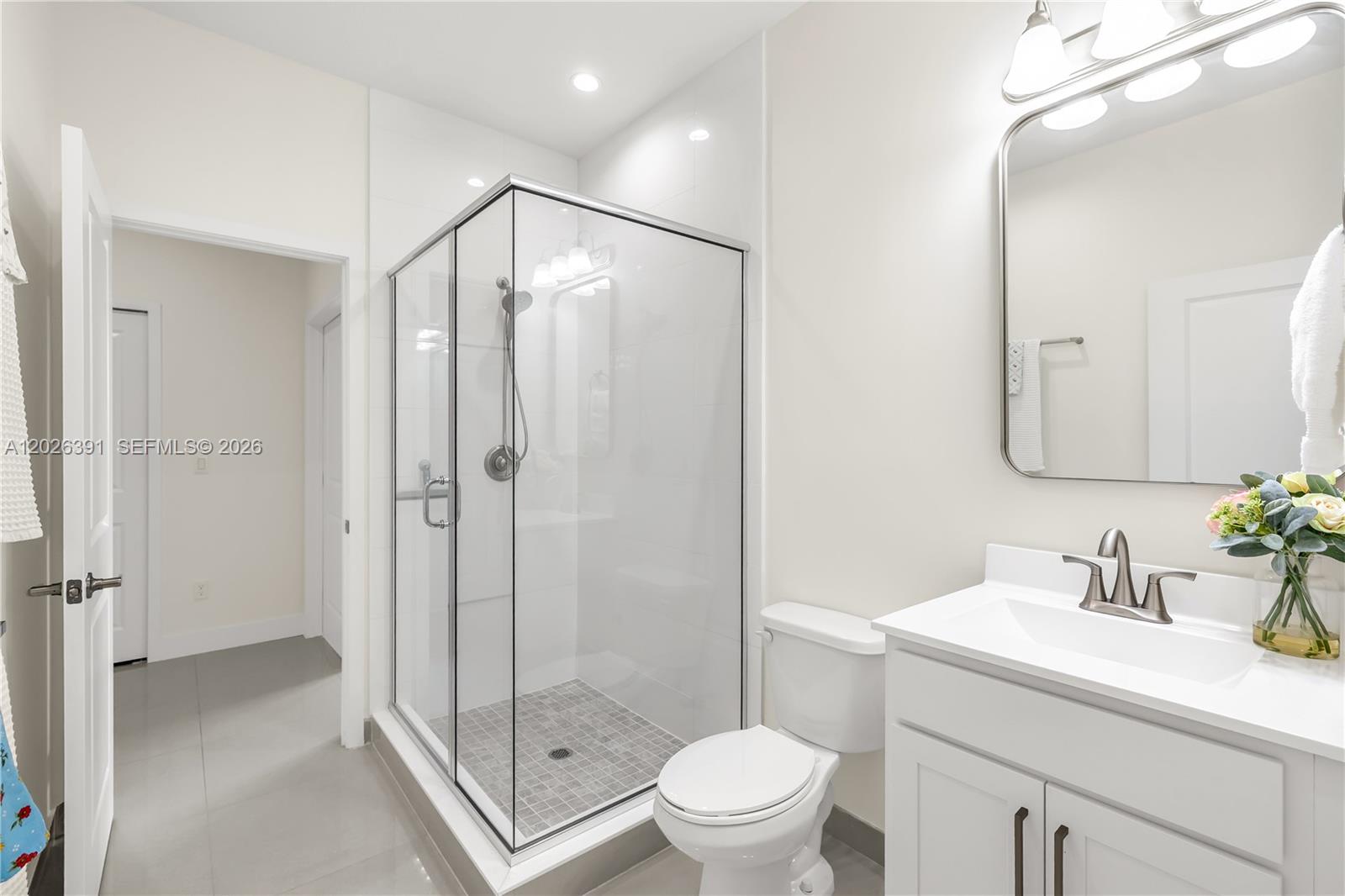 14606 Southwest 22nd Terrace Miami, FL 33175 - Photo 38 of 43 a bathroom with a shower sink vanity mirror and toilet